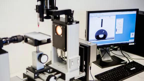 Close-up of a DataPhysics contact angle measurement system with a liquid droplet displayed on the monitor