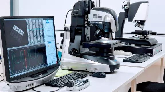  Keyence VHX digital microscope and optical microscope set up for micro-scale dimensional measurement, with a profile trace on screen