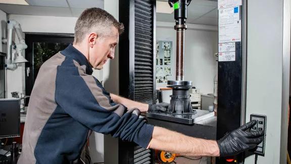 Loading a sample into the compression testing machine