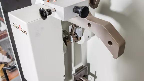 Zwick Roell pendulum impact tester with raised hammer and clamped specimen support