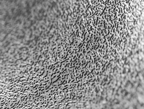 Close-up of a textured metal surface showing fine wear patterns