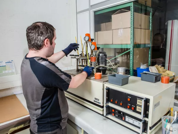 Technician setting up an HDT and Vicat test