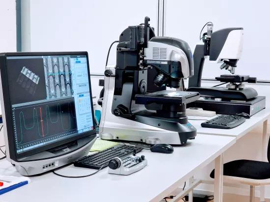  Keyence VHX digital microscope and optical microscope set up for micro-scale dimensional measurement, with a profile trace on screen