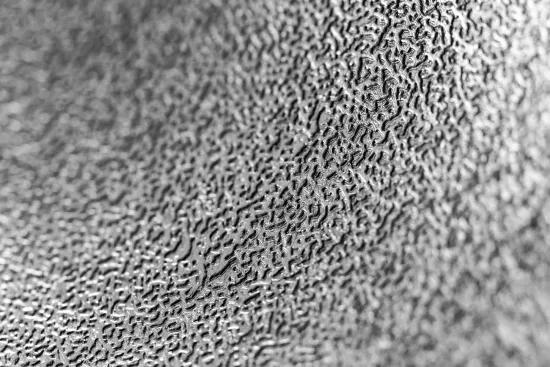 Close-up of a textured metal surface showing fine wear patterns