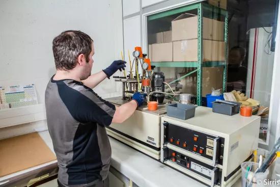 Technician setting up an HDT and Vicat test